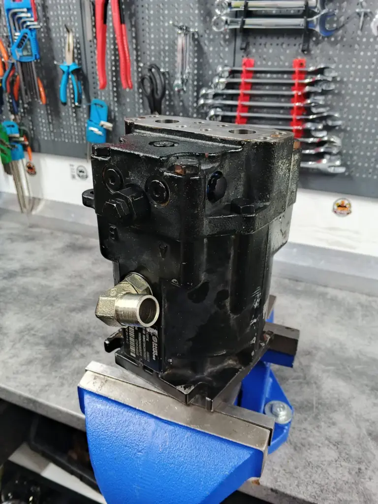 Hidromotor Sauer Danfoss fixat în menghină, cu plăcuța de identificare vizibilă